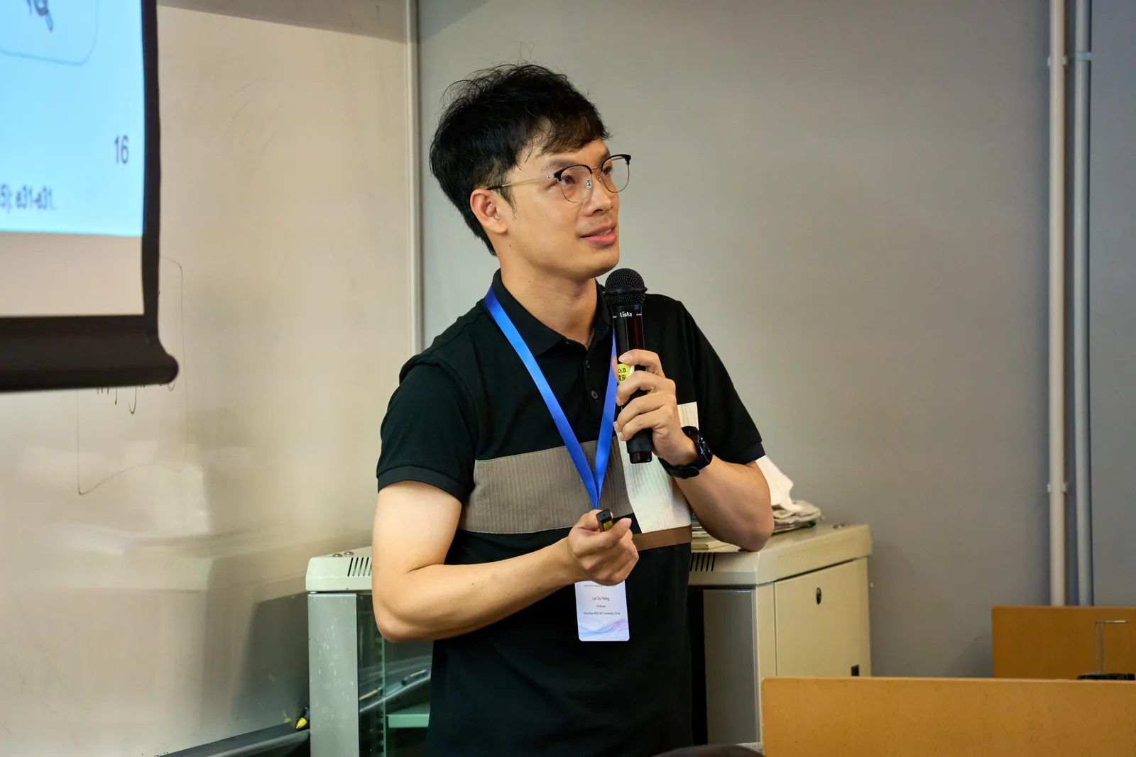 A workshop speaker presenting with a microphone