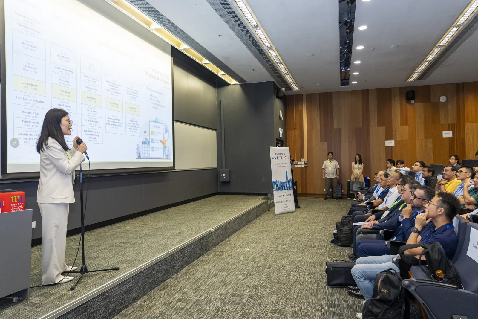 A presenter speaking to a full lecture theatre